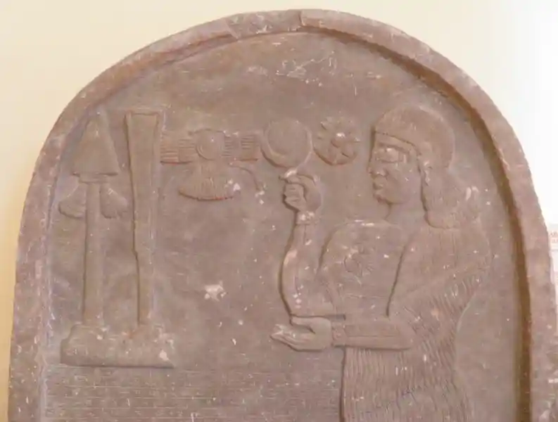 Winged disc, crescents, and eight-pointed star engraved on a marble stele